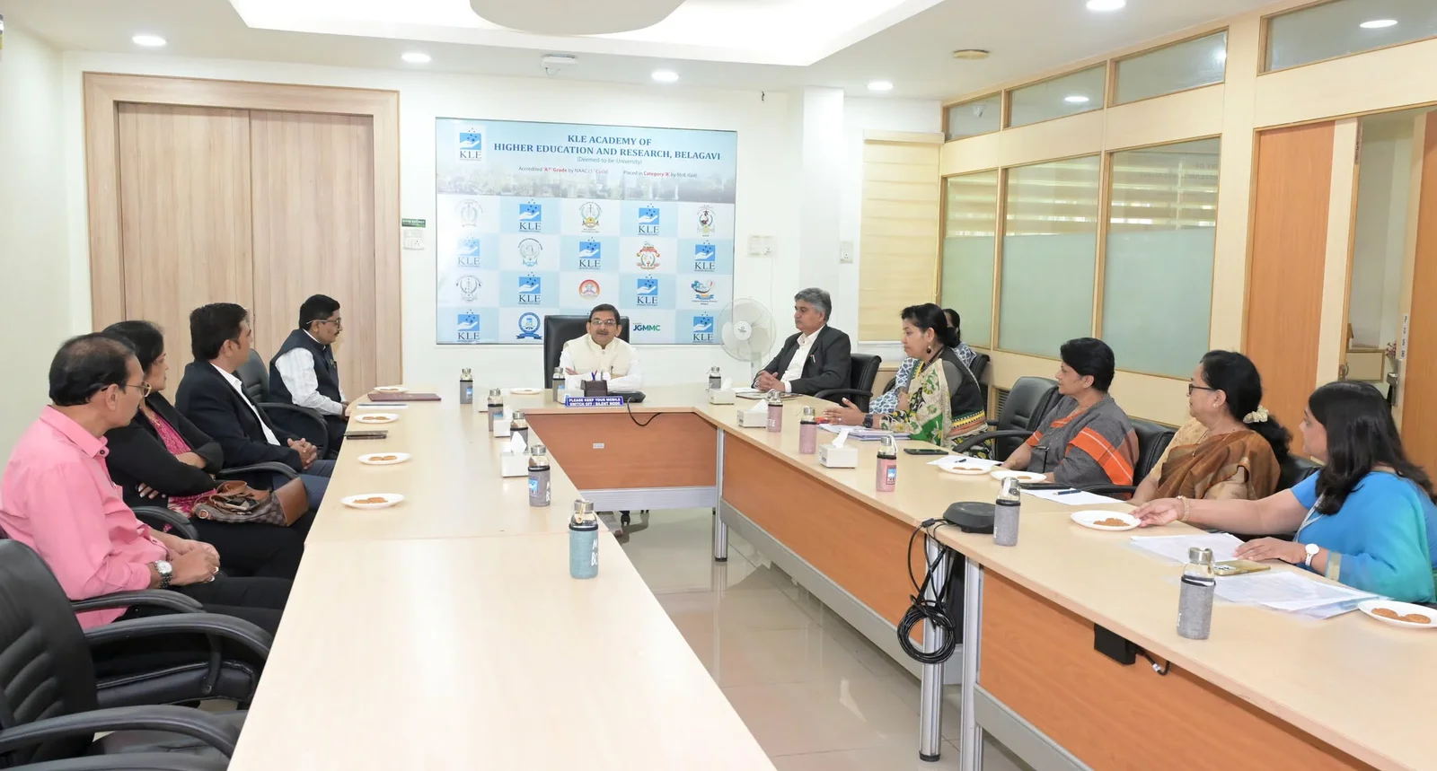 KAHER and Nivaris representatives in discussion around a conference table