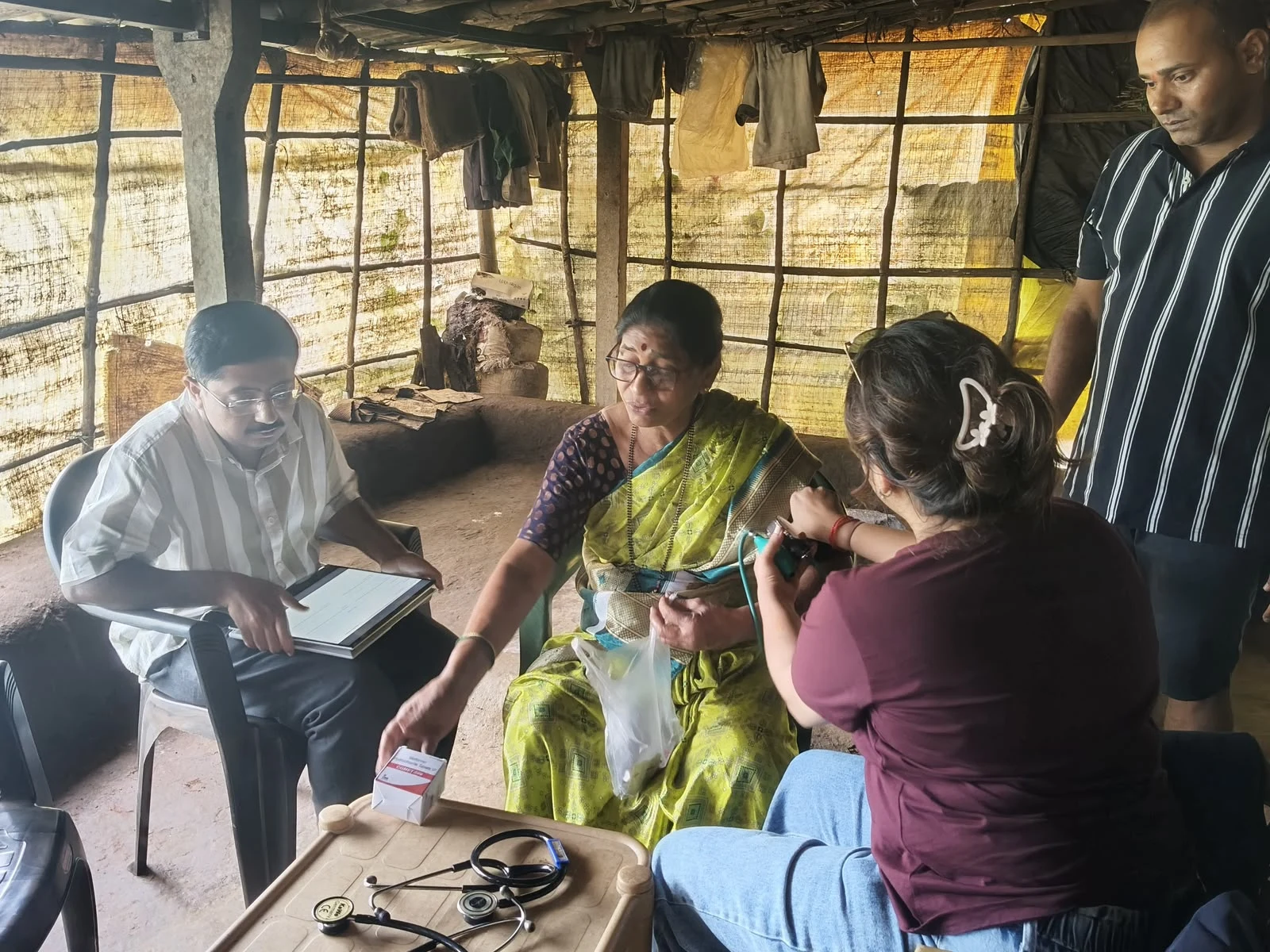 A team member adjusting a blood pressure cuff during a community health check
